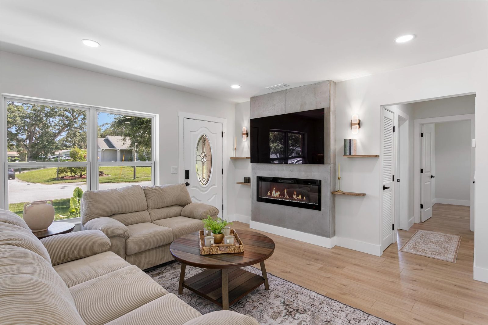 Renovated living room with a modern fireplace and wood flooring